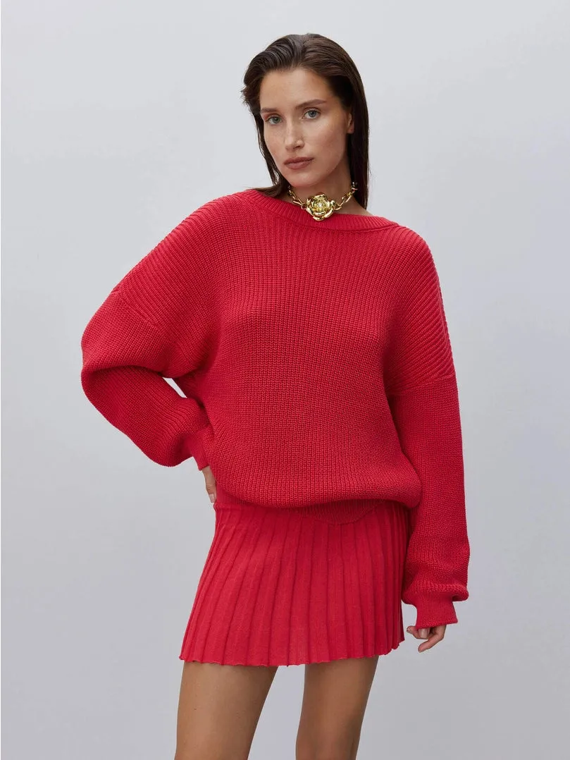 Cutout sweater with flower accessory. Red